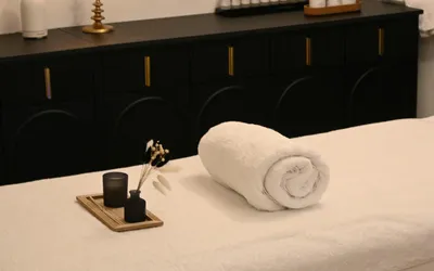 spa treatment room with candle and towels