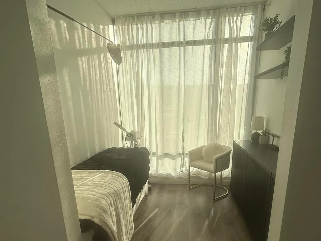 The private treatment room at Soul to Sole Sanctuary, with a massage table, sheer-curtained windows, and soft natural light