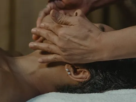 practitioner performing facial zone therapy
